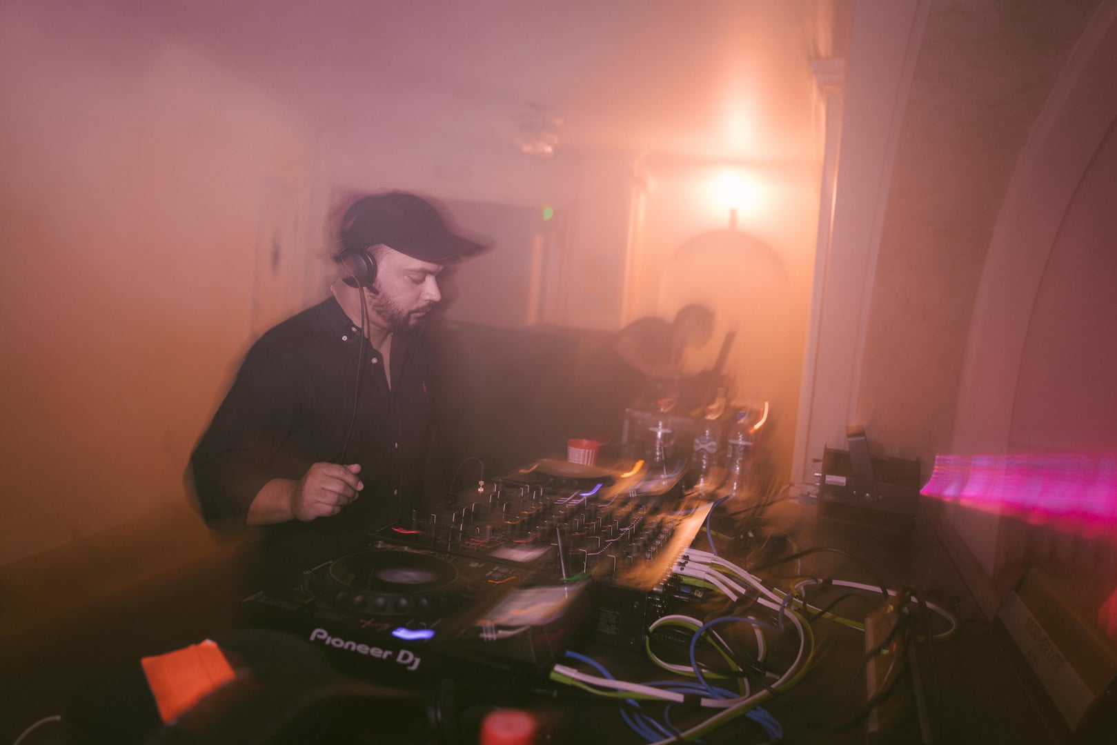 DJ entre humo y luces en el foyer